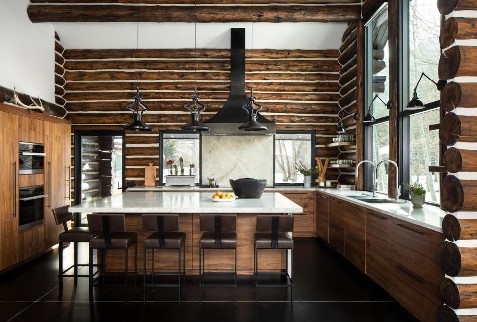 Dramatic counter-to-ceiling windows flood a gourmet kitchen with light