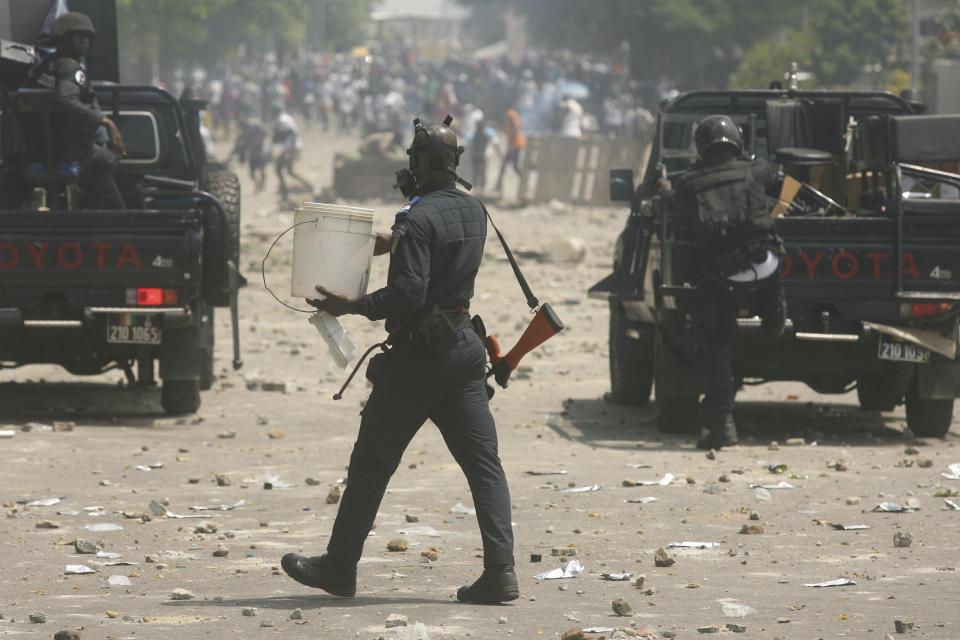 Supporters of the former Ivorian president Laurent Gbagbo protest as they claim they are being forbidden to greet Gbagbo on his arrival in Abidjan, Ivory Coast, Thursday, June 17, 2021. After nearly a decade, Gbagbo returns to his country after his acquittal on war crimes charges was upheld at the International Criminal Court earlier this year. (AP Photo/Diomande Ble Blonde)