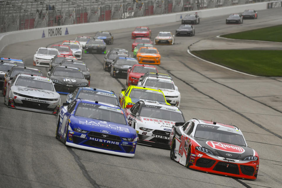 Cole Cluster, left, and Christopher Bell, right, lead at the start of the NASCAR XFinity at Atlanta Motor Speedway, Saturday, Feb. 23, 2019, in Hampton, Ga. (AP Photo/John Amis)