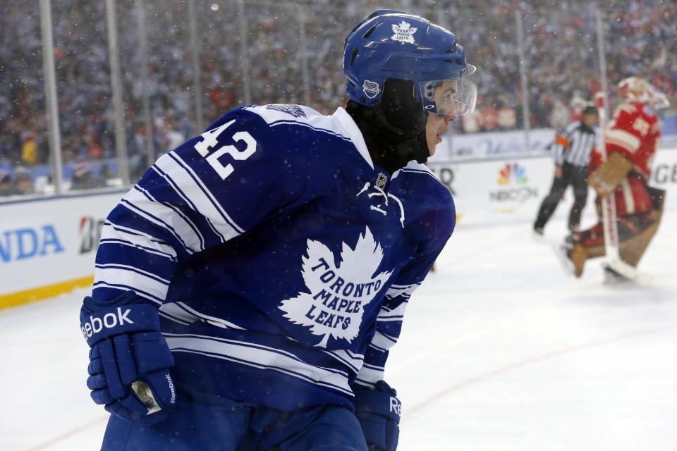 Toronto Maple Leafs center Tyler Bozak (42) skates back to the bench as Detroit Red Wings goalie Jimmy Howard (35) leaves the net after Bozak's game winning shot during a shootout in the Winter Classic outdoor NHL hockey game at Michigan Stadium in Ann Arbor, Mich., Wednesday, Jan. 1, 2014. (AP Photo/Paul Sancya)