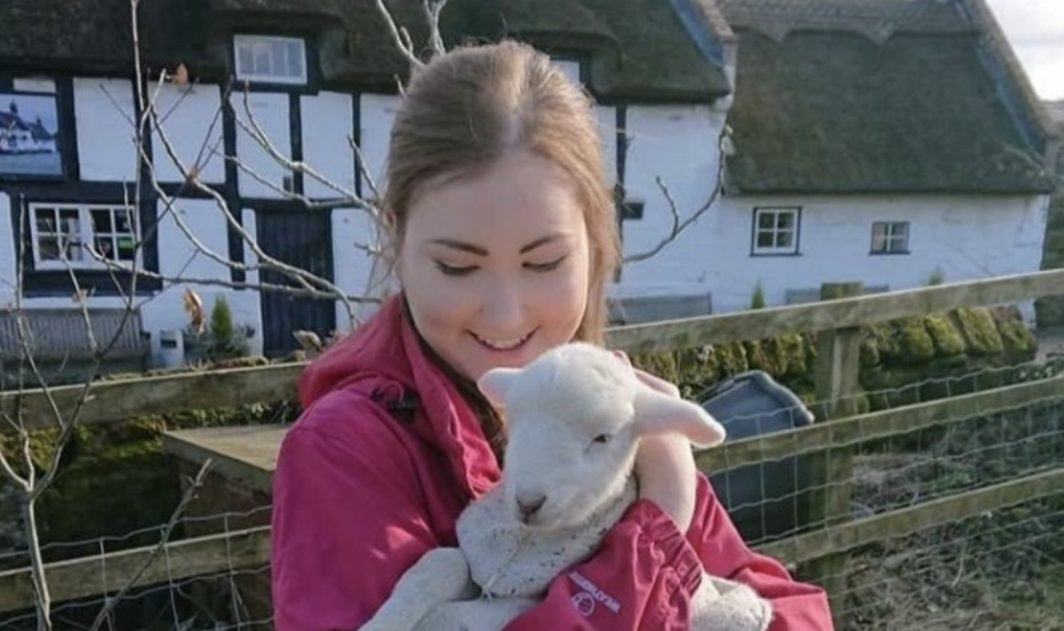 Claudia Marsh holding a lamb.