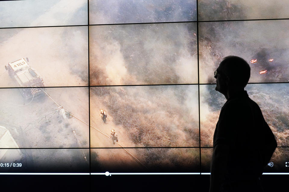 Falco Kuester, a researcher at ALERTCalifornia, a program run by the University of California San Diego, looks at imagery of firefighters at a fire from one of the program's cameras, Monday, Sept. 18, 2023, in San Diego. California's main firefighting agency, Cal Fire, in July started trying out an artificial intelligence system that looks for smoke from more than 1,000 mountaintop cameras feeds. (AP Photo/Gregory Bull)