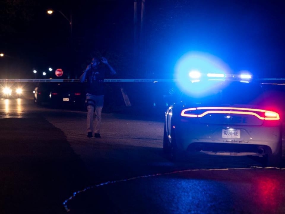 A police officer investigates at the scene where a man was taken into custody following a series of shootings throughout the city on September 7, 2022 in Memphis.