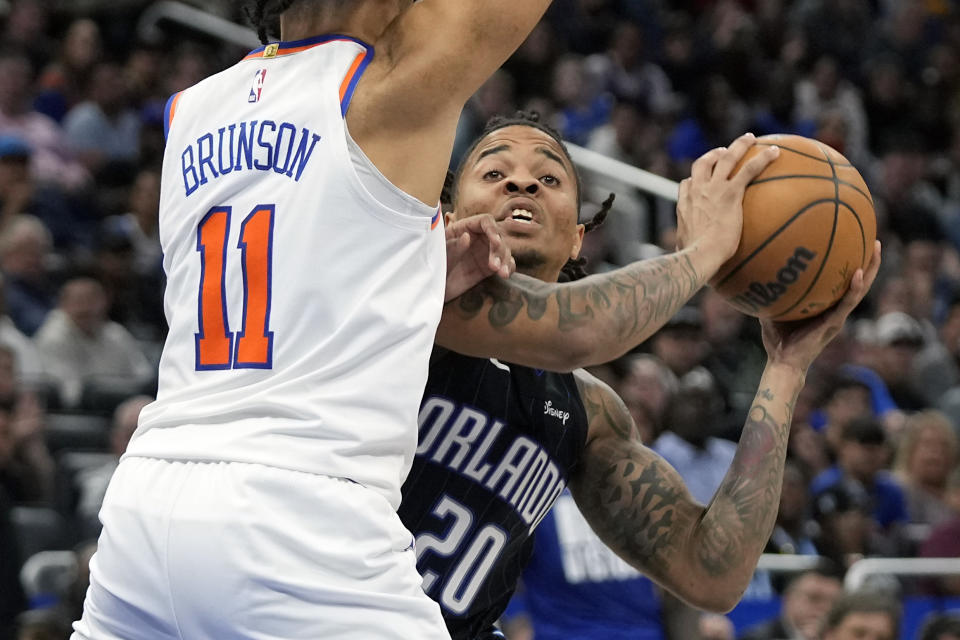 Orlando Magic's Markelle Fultz (20) tries to find a teammate to pass to as New York Knicks' Jalen Brunson (11) defends during the second half of an NBA basketball game Tuesday, Feb. 7, 2023, in Orlando, Fla. (AP Photo/John Raoux)