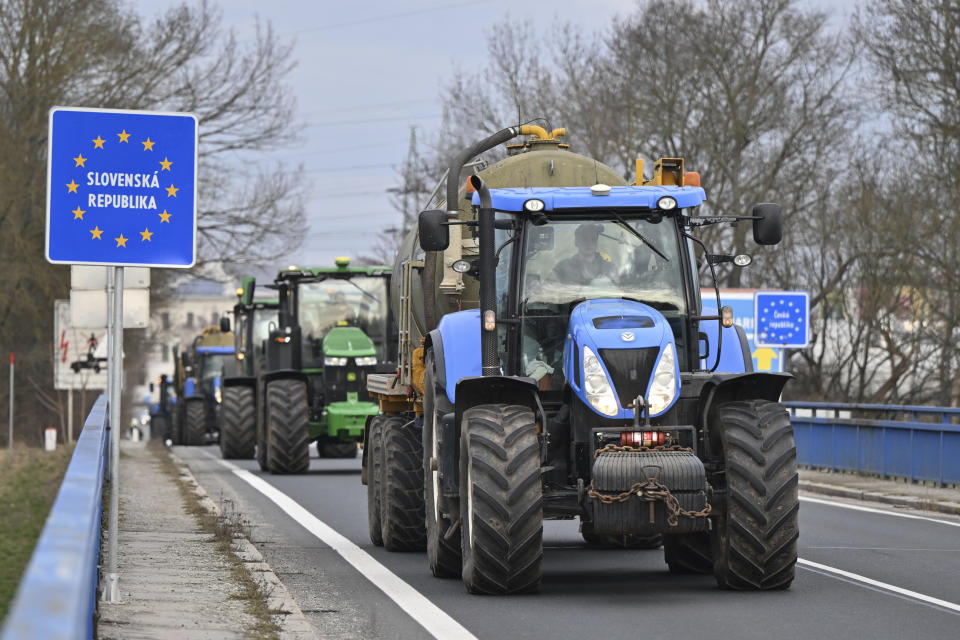Czech farmers in tractors make their way to the Hodonín/Holíč, Czech-Slovakia border crossing, in Czech Republic, Thursday, Feb. 22, 2024, to meet their colleagues from neighboring countries and join forces in their protests against European Union agriculture policies, bureaucracy and overall conditions for their business. (Vaclav Salek/CTK via AP)