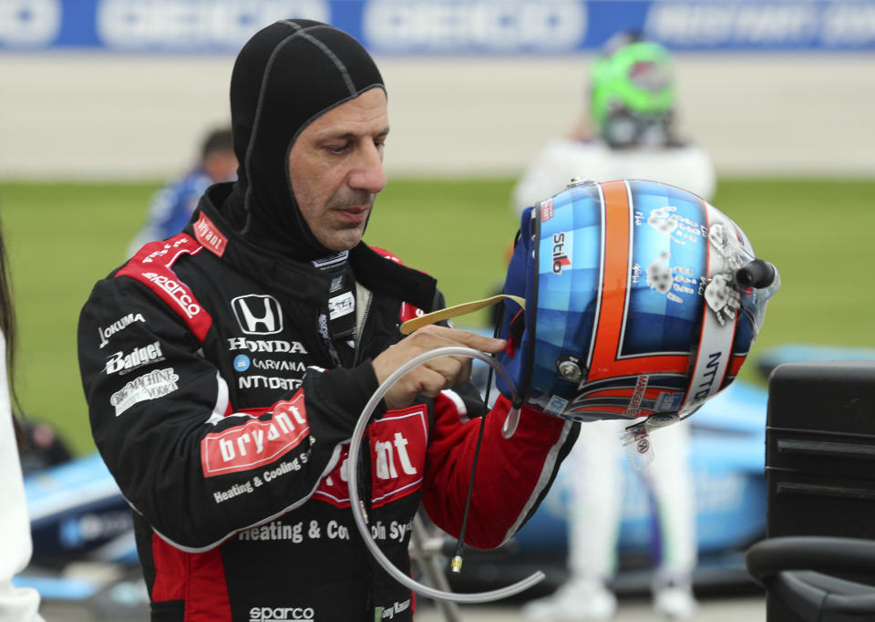 FILE - Tony Kanaan gets ready to put on his helmet before the IndyCar Series race at Texas Motor Speedway in Fort Worth, Texas., in this Saturday, May 1, 2021, file photo. With nine career starts at Gateway, Kanaan has the most experience at the track of any driver in the field. “My last IndyCar race of the season, so kind of sad,” said Kanaan, who has a two-year deal to run the ovals for Ganassi. “But excited to go to St. Louis and get Ganassi and the 48 car a win.” (AP Photo/Richard W. Rodriguez, File)