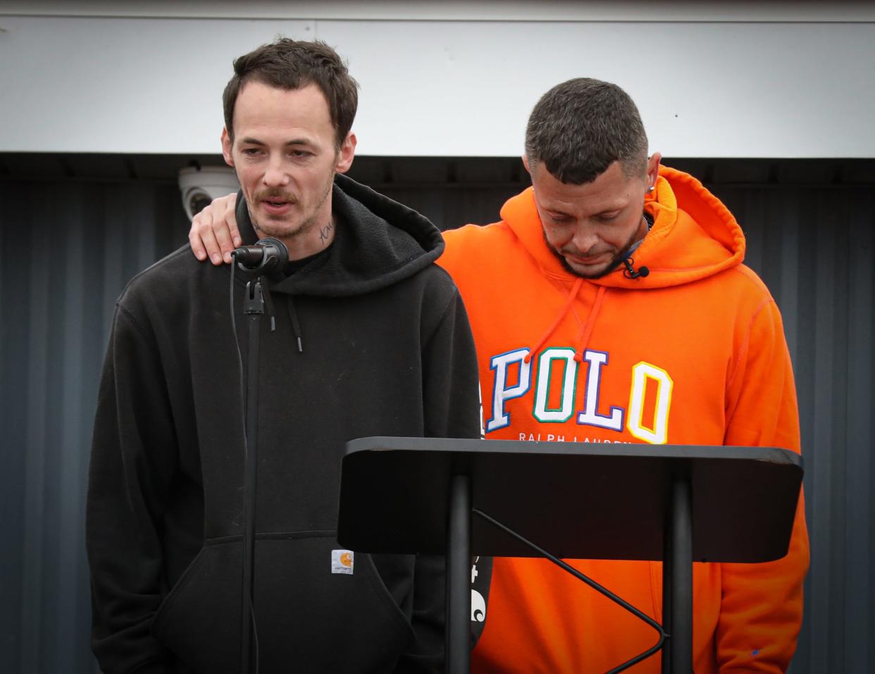 Nicholas Phillips and Michael Hatfield, both uncles to Alanah and Zayn Phillips, speak to the crowd at the vigil held at the Swan Boat Club, Newport, on Friday.
