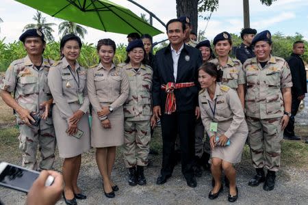 Thailand's Prime Minister Prayuth Chan-ocha poses for photo with local government officers at a farmer school in Suphan Buri province, Thailand September 18, 2017. Picture taken September 18, 2017. REUTERS/Athit Perawongmetha