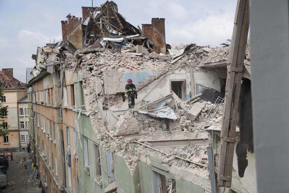 A rescuer working in an apartment building partially destroyed by a missile strike in Lviv (UKRAINIAN EMERGENCY SERVICE/AFP)