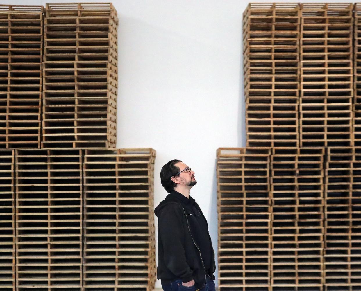 Adam Berkley, general manager of OnQ Solutions, takes in what will soon be the production area of the firm's new location in what was once the JCPenney story in the former Chapel Hill Mall in Akron.