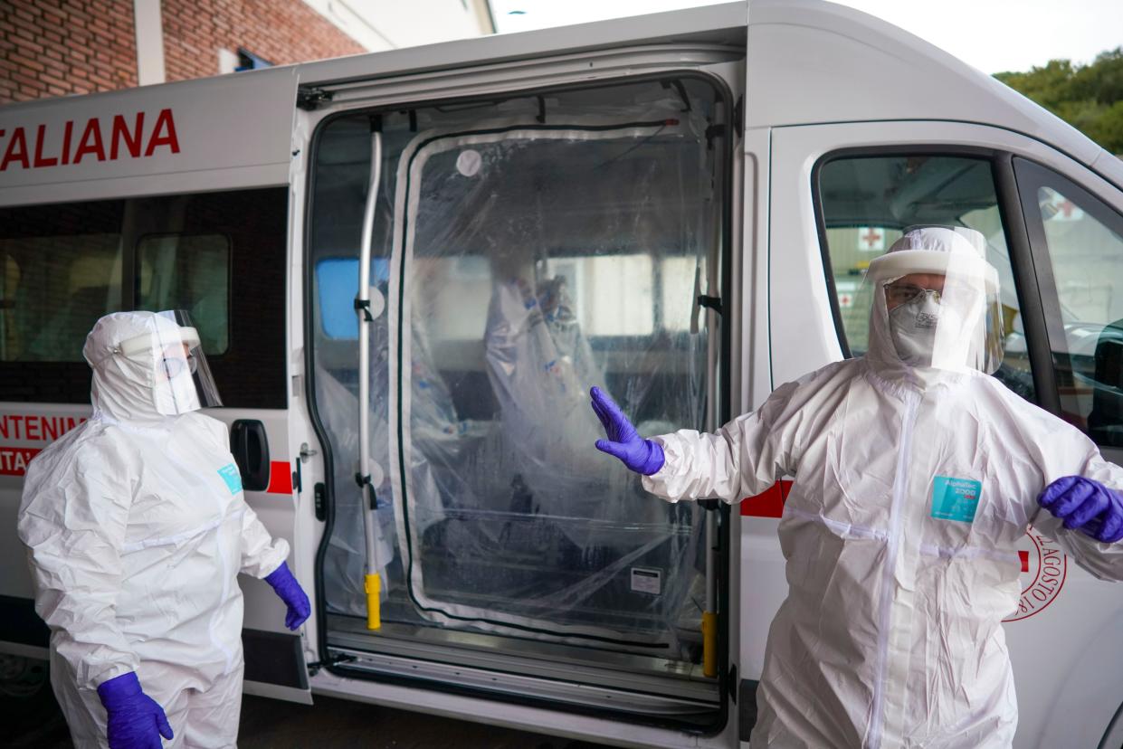 Red Cross personnel prepare for the transport of a Coronavirus patient during a simulation, in Rome, on Friday, March 6, 2020.