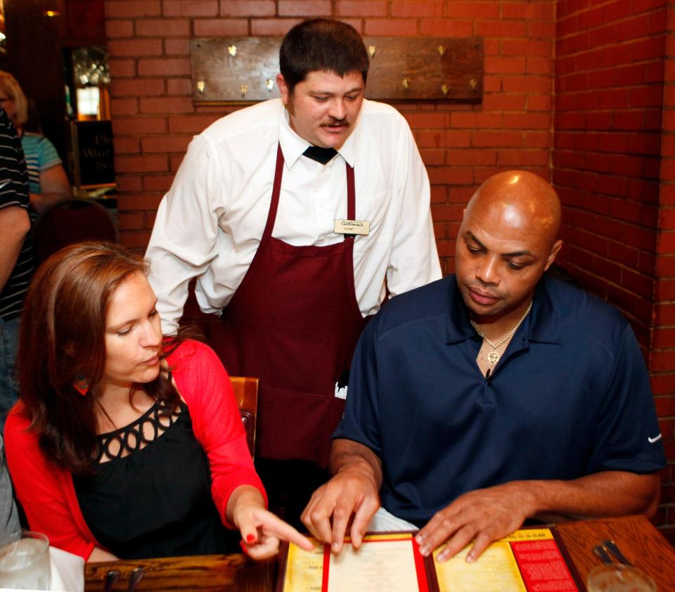 Michael Sharp, a server at Cattlemen's Steakhouse, middle, discusses the menu with former NBA player and TNT analyst Charles Barkley as Elly Trickett, executive editor of weightwatchers.com, gives Barkley advice on what to order at Cattlemen's Steakhouse during a tour of Oklahoma City, Friday, June 1, 2012. Photo by Nate Billings, The Oklahoman