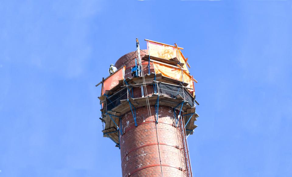 Due to advanced deterioration of the 3039 stack, crews removed the top five feet of the structure and installed a new cap to stabilize and protect the top of the stack.
