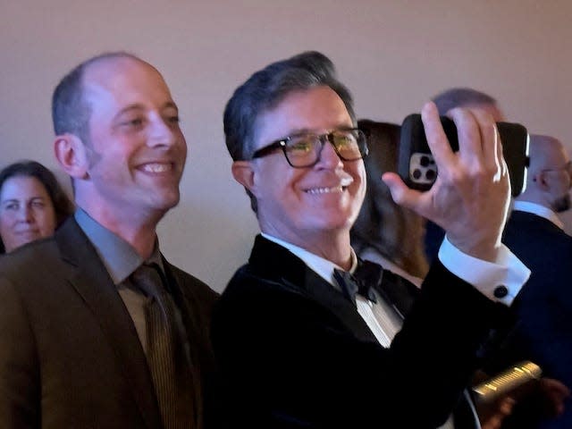 Stephen Colbert takes the iPhone for a selfie photo in the lobby during the 75th Emmy Awards.