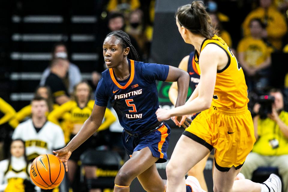 Illinois guard De'Myla Brown (5) dribbles the ball as Iowa guard Caitlin Clark, right, defends during a NCAA Big Ten Conference women's basketball game, Sunday, Jan. 23, 2022, at Carver-Hawkeye Arena in Iowa City, Iowa.