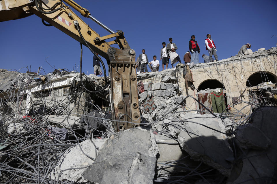 People inspect the rubble of a prison facility hit by a Saudi-led coalition airstrike that killed at least 87 people, in a stronghold of Houthi rebels on the border with Saudi Arabia, in the northern Saada province of Yemen, Saturday, Jan. 22, 2022. Internet access remained largely down on Sunday after another Saudi-led coalition airstrike hit a telecommunications center Friday at the Red Sea port city of Hodeida. (AP Photo/Hani Mohammed)