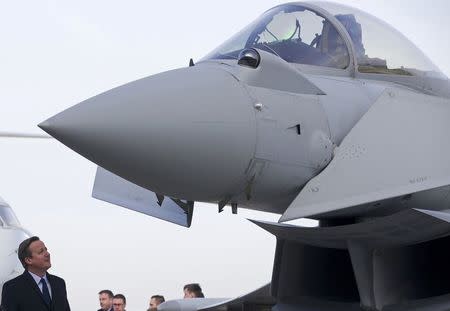 Prime Minister David Cameron looks at an RAF Eurofighter Typhoon fighter jet during his visit to Royal Air Force station RAF Northolt in London, Britain November 23, 2015. REUTERS/Justin Tallis/pool