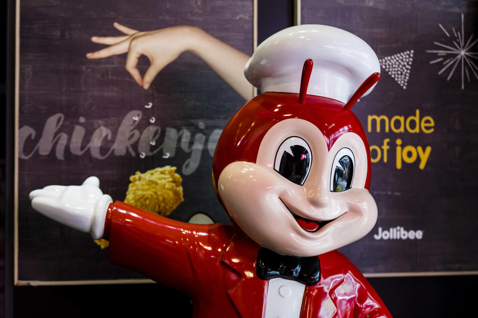 FILE PHOTO: A Jollibee Foods Corporation's mascot is seen at one of the company's restaurant in Hong Kong on 14 Jun 2018. (Photo by S3studio/Getty Images)