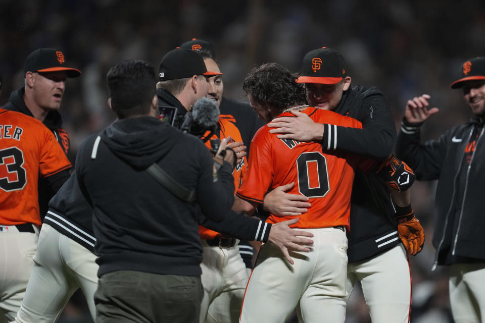 San Francisco Giants' Brett Wisely (0) is congratulated after hitting a game-wining, two-run home run against the Los Angeles Dodgers during the ninth inning of a baseball game Friday, June 28, 2024, in San Francisco. (AP Photo/Godofredo A. Vásquez)