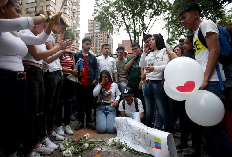 People gather in the street where Dilan Cruz was injured, allegedly by a tear gas canister fired by riot police during the national strike on the previous day, in Bogota