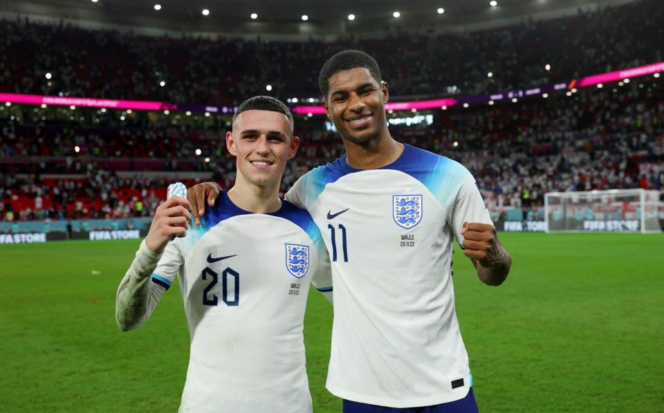 Phil Foden and Marcus Rashford of England celebrate following the FIFA World Cup Qatar 2022 Group B match between Wales and England - Eddie Keogh/Getty Images