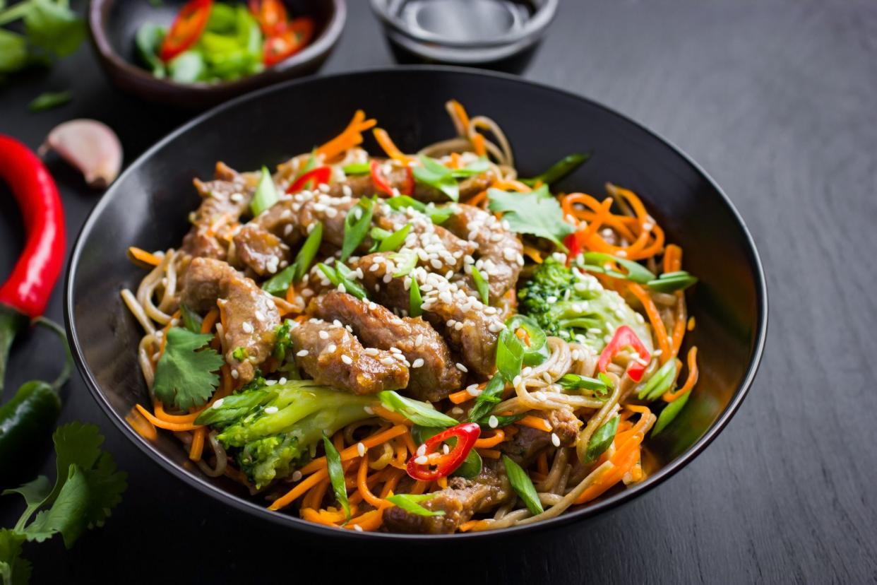 Bowl of soba noodles with beef and vegetables. Asian food. Top view.