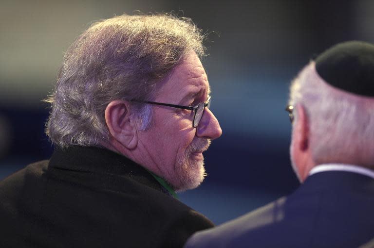 US director Steven Spielberg (L), sits inside a tent erected in front of the entrance of the former Nazi concentration camp Auschwitz-Birkenau