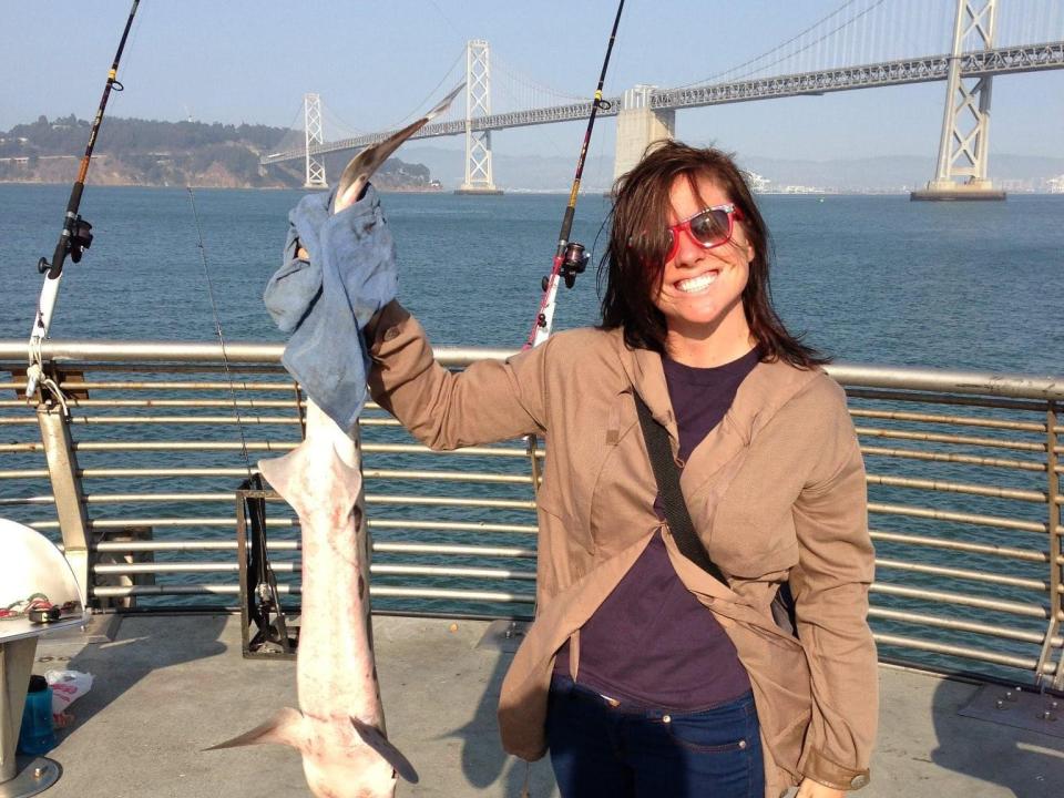 M.E. Thomas holding a fish in San Francisco.