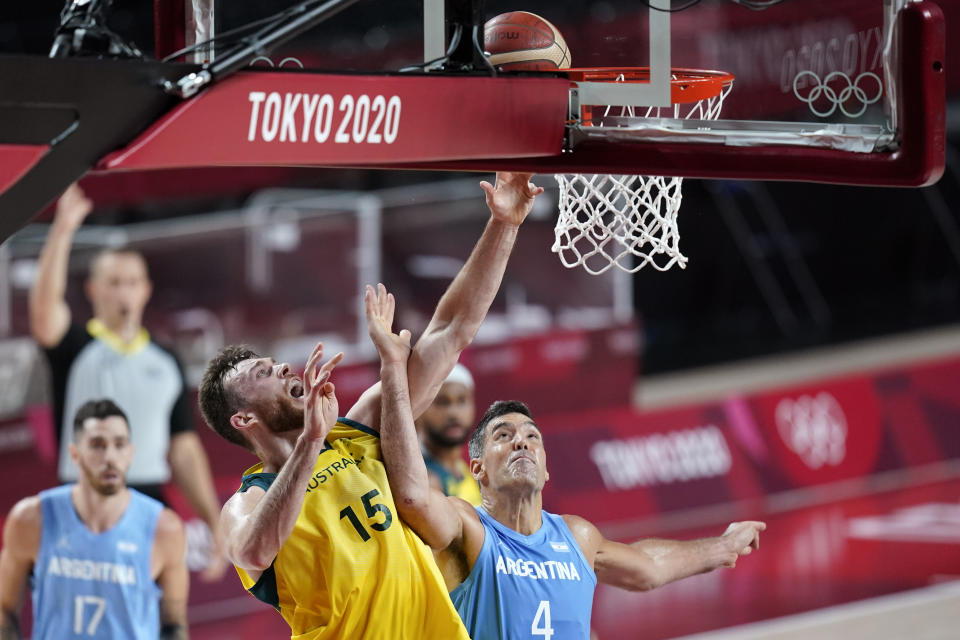 Australia's Nic Kay (15) shoots over Argentina's Luis Scola (4) during a men's basketball quarterfinal round game at the 2020 Summer Olympics, Tuesday, Aug. 3, 2021, in Saitama, Japan. (AP Photo/Charlie Neibergall)