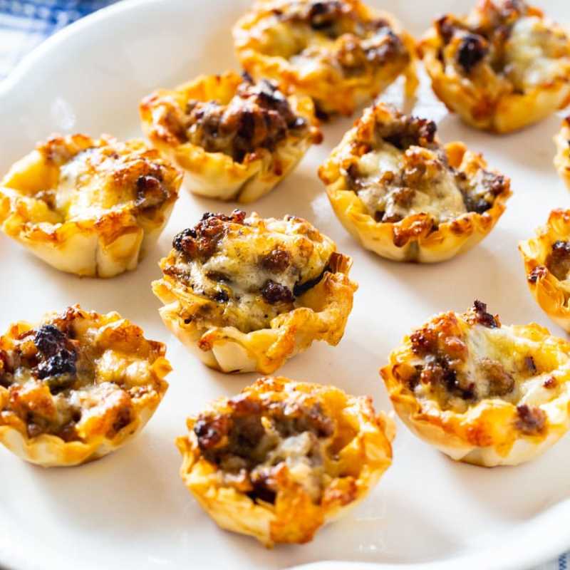 <p>Spicy Southern Kitchen</p><p>Sausage ranch phyllo cups make a quick and easy appetizer. Only four ingredients and 12 minutes in the oven!</p><p><strong>Get the recipe: <a href="https://spicysouthernkitchen.com/sausage-ranch-phyllo-cups/" rel="nofollow noopener" target="_blank" data-ylk="slk:Sausage Ranch Phyllo Cups;elm:context_link;itc:0;sec:content-canvas" class="link "><em>Sausage Ranch Phyllo Cups</em></a></strong></p>