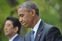 US President Barack Obama (R) pauses while speaking during a joint press conference at the White House on April 28, 2015 in Washington, DC