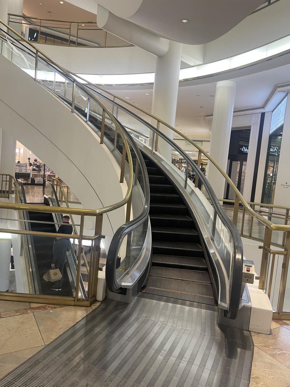 A curved escalator in a mall