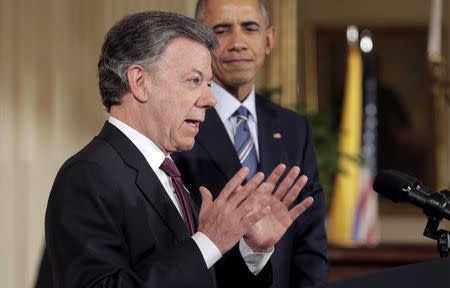 U.S. President Barack Obama listens as President Juan Manuel Santos of Colombia speaks during a reception in the East Room of the White House in Washington February 4, 2016. REUTERS/Joshua Roberts