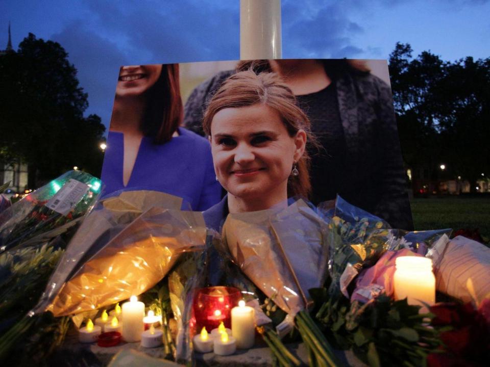 Floral tributes and candles are placed by a picture of slain Labour MP Jo Cox at a vigil in Parliament square in London on 16 June, 2016 (Daniel Leal-Olivas/AFP/Getty)