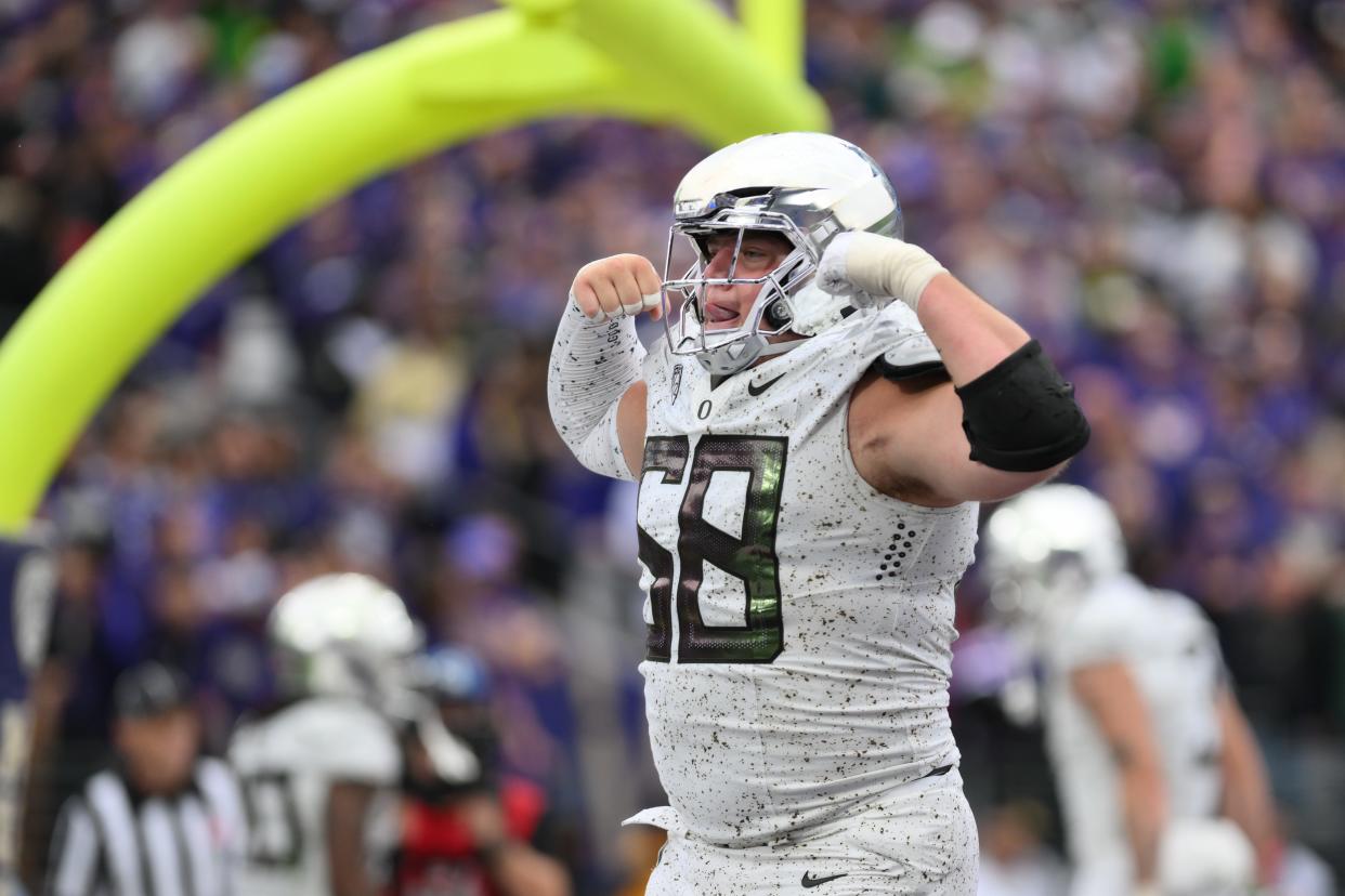 Oct 14, 2023; Seattle, Washington, USA; Oregon Ducks offensive lineman Jackson Powers-Johnson (58) celebrates after the Ducks scored a touchdown against the Washington Huskies during the second half at Alaska Airlines Field at Husky Stadium. Mandatory Credit: Steven Bisig-USA TODAY Sports