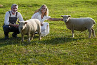 Jeff and Jamie Campion pose with their Southdown Babydoll sheep Buttermilk and Biscuit in their backyard Wednesday, July 3, 2024, in Thompson Station, Tenn. (AP Photo/George Walker IV)