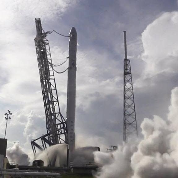 SpaceX checks its next Falcon 9 rocket to fly in a static engine test ahead of a planned April 13, 2015 launch to send an unmanned Dragon cargo ship to the International Space Station, then attempt a reusable rocket landing on an ocean platform