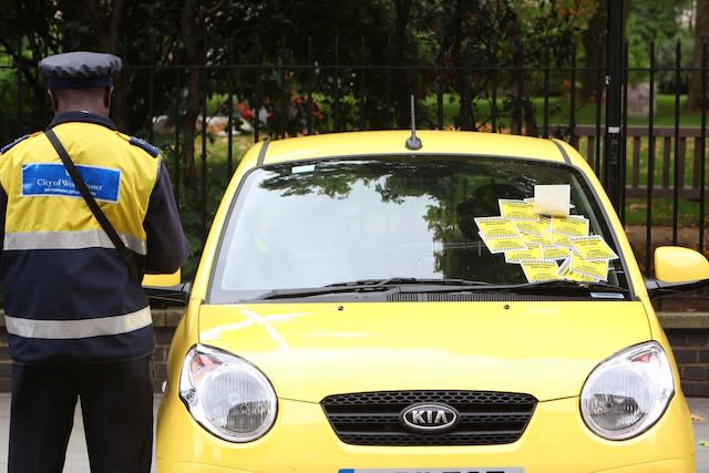 A traffic warden stands beside a car in central London which has been ticketed as part of a new T-Mobile advert where the brand has handed out thousands of pounds in Â£5, Â£10, Â£20 and Â£50 notes inside imitation parking fines on cars in and around the Capital. PRESS ASSOCIATION Photo. Issue date: Tuesday September 13, 2011. T-Mobile secretly filmed the reactions from unsuspecting members of the public for a new TV advert which launches on Friday night 9.15pm on Channel 5. Photo credit should read: Geoff Caddick/PA