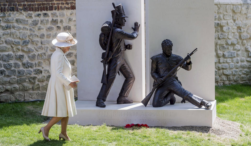 FILE - Camilla, Duchess of Cornwall, walks by a newly unveiled monument to the Battle of Waterloo at Hougoumont Farm in Braine-l'Alleud, near Waterloo, Belgium on Wednesday, June 17, 2015. Britain's queen consort, Camilla, has come a long way. On May 6, she will be crowned alongside her husband and officially take her first turns on the world stage as Queen Camilla. It’s been a remarkable and painstakingly slow transformation over five decades. Camilla was long reviled as the other woman in Charles' marriage to Diana and considered a liability to the British monarchy. (AP Photo/Geert Vanden Wijngaert, Pool, File)