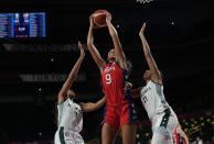 United States' A'Ja Wilson (9), center, grabs a rebound between Nigeria's Adaora Elonu (11), left, and Atonye Nyingifa (21) during women's basketball preliminary round game at the 2020 Summer Olympics, Tuesday, July 27, 2021, in Saitama, Japan. (AP Photo/Eric Gay)