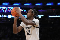 Marquette's Olivier-Maxence Prosper (12) shoots for three points in the first half of an NCAA college basketball game against Xavier for the championship of the Big East men's tournament, Saturday, March 11, 2023, in New York. (AP Photo/John Minchillo)