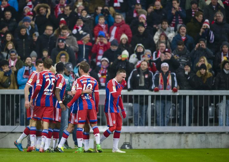 Bayern Munich's players celebrate during the German first division Bundesliga football match FC Bayern Munich vs 1 FC Cologne in Munich, Germany, on February 27, 2015