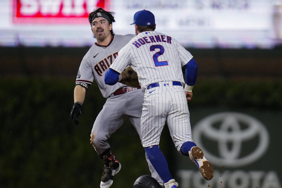 Chicago Cubs second baseman Nico Hoerner, right, chases Arizona Diamondbacks' Corbin Carroll before tagging him out during the third inning of a baseball game Thursday, Sept. 7, 2023, in Chicago. (AP Photo/Erin Hooley)