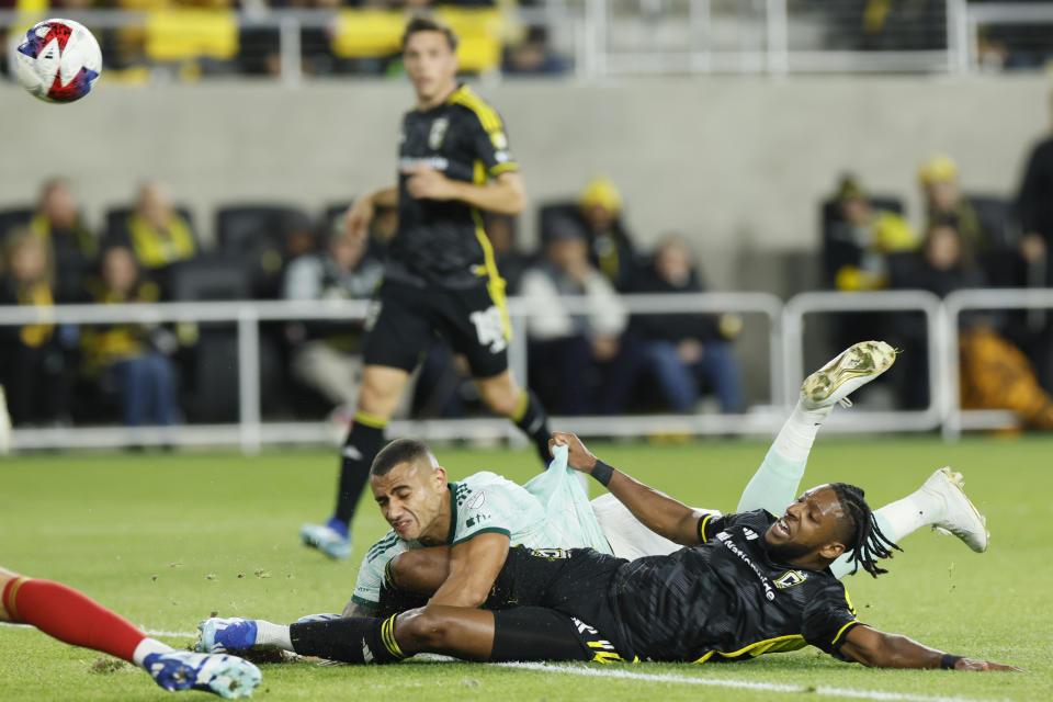 Atlanta United's Giorgos Giakoumakis, top, and Columbus Crew's Steven Moreira collide during the first half of an MLS playoff soccer match, Sunday, Nov. 12, 2023, in Columbus, Ohio. (AP Photo/Jay LaPrete)