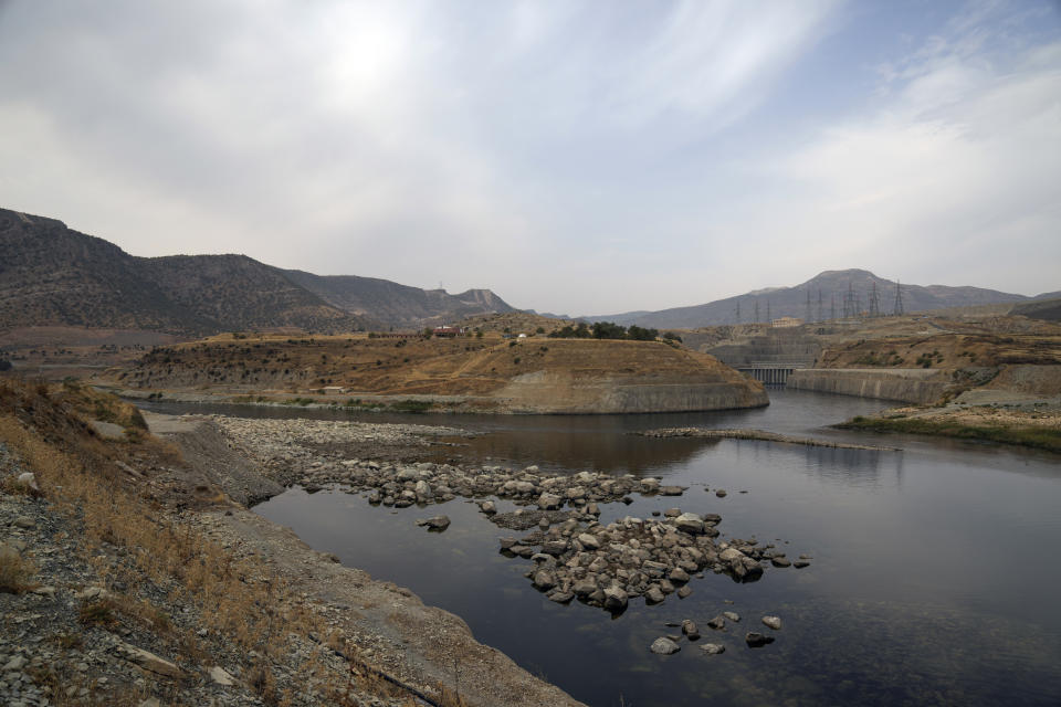 Tigris river flows from the Ilisu Dam reservoir is seen in Mardin province, Turkey, Tuesday, Oct. 18, 2022. Before Turkey began operating the dam in May 2020, all the waters of Tigris River flowed into Iraq. Now how much water comes down depends on Ankara's consideration of Iraq's month-to-month requests for a minimum flow, weighed against Turkey's own needs. (AP Photo/Khalil Hamra)