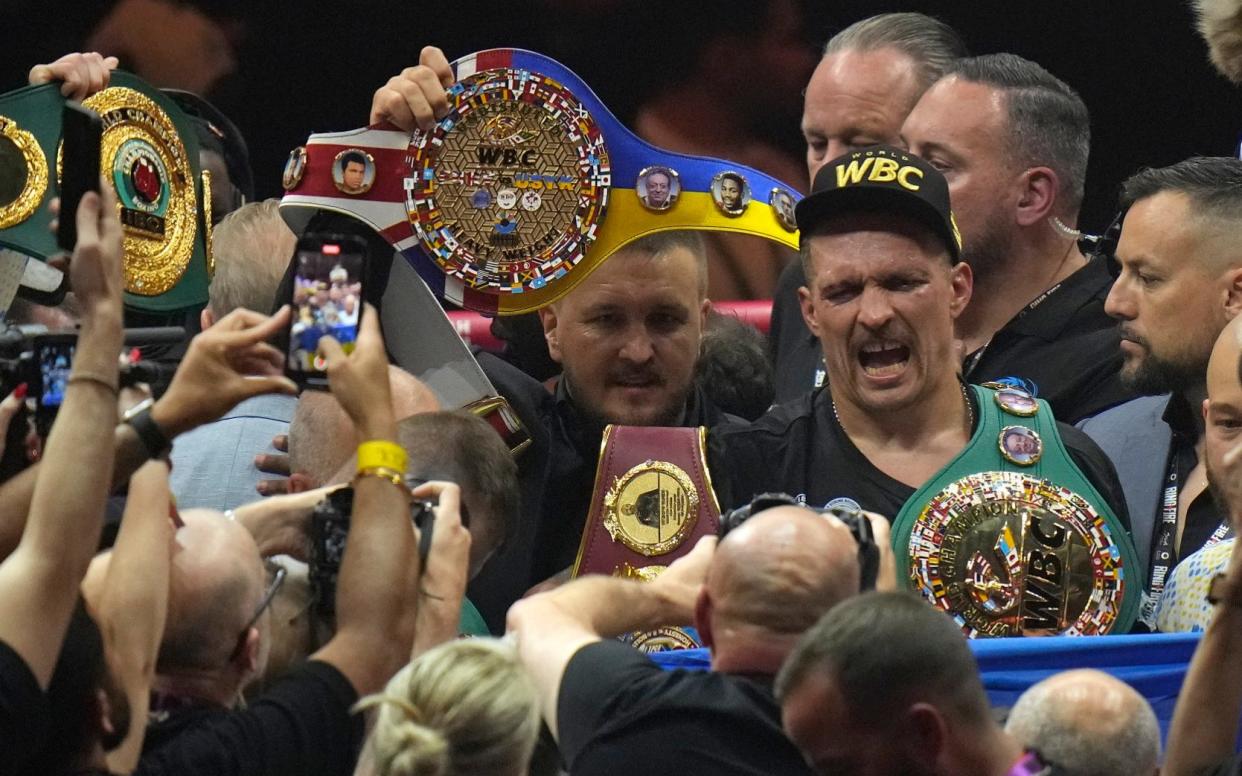 Oleksandr Usyk celebrates after beating Tyson Fury