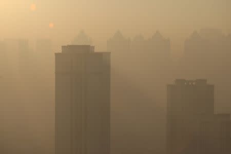 Buildings are seen in heavy smog in Harbin, Heilongjiang province, China, December 17, 2016. REUTERS/Stringer