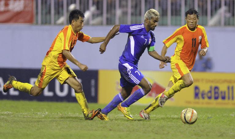 Maldives' Ali Asfaq (C) vies with Bhutan's Pema (L) and Chencho during the SAFF Championship football match in Kathmandu on September 4, 2013