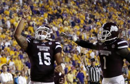 Mississippi State QB Dak Prescott (15) points to the sky after scoring a touchdown against LSU. (AP)