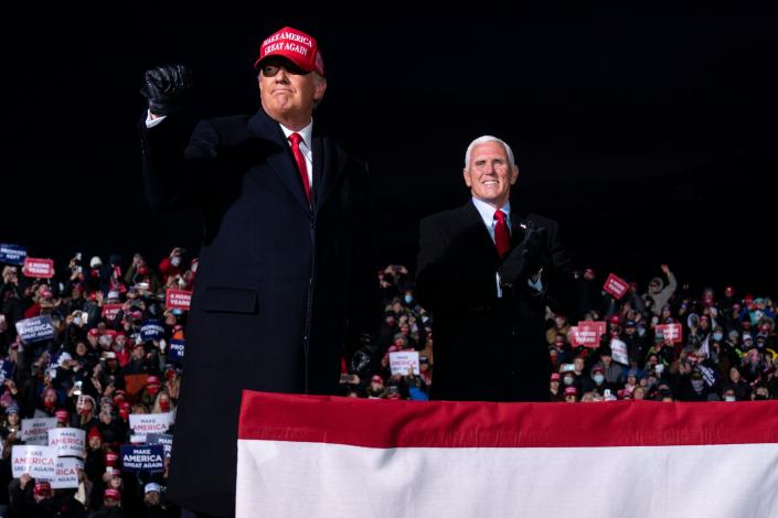 President Donald Trump and Vice President Mike Pence arrive for a campaign rally at Cherry Capital Airport, Monday, Nov. 2, 2020, in Traverse City, Mich. (AP Photo/Evan Vucci)